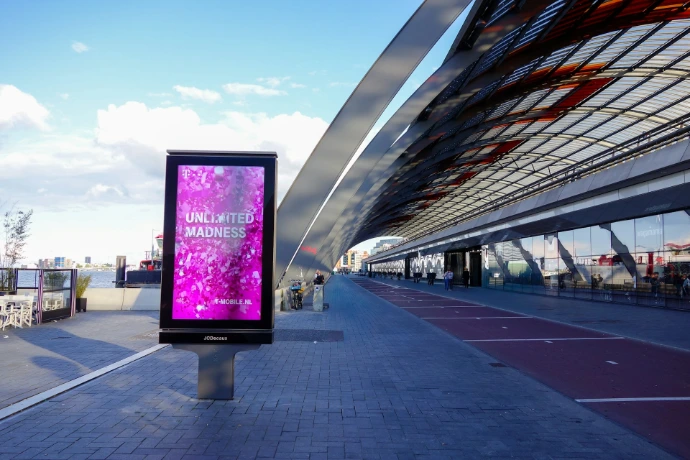 Modern digital billboard with pink abstract art outdoors