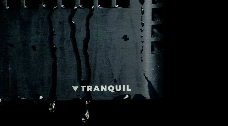 Close-up of water droplets dripping down a tranquil rugged computer chassis